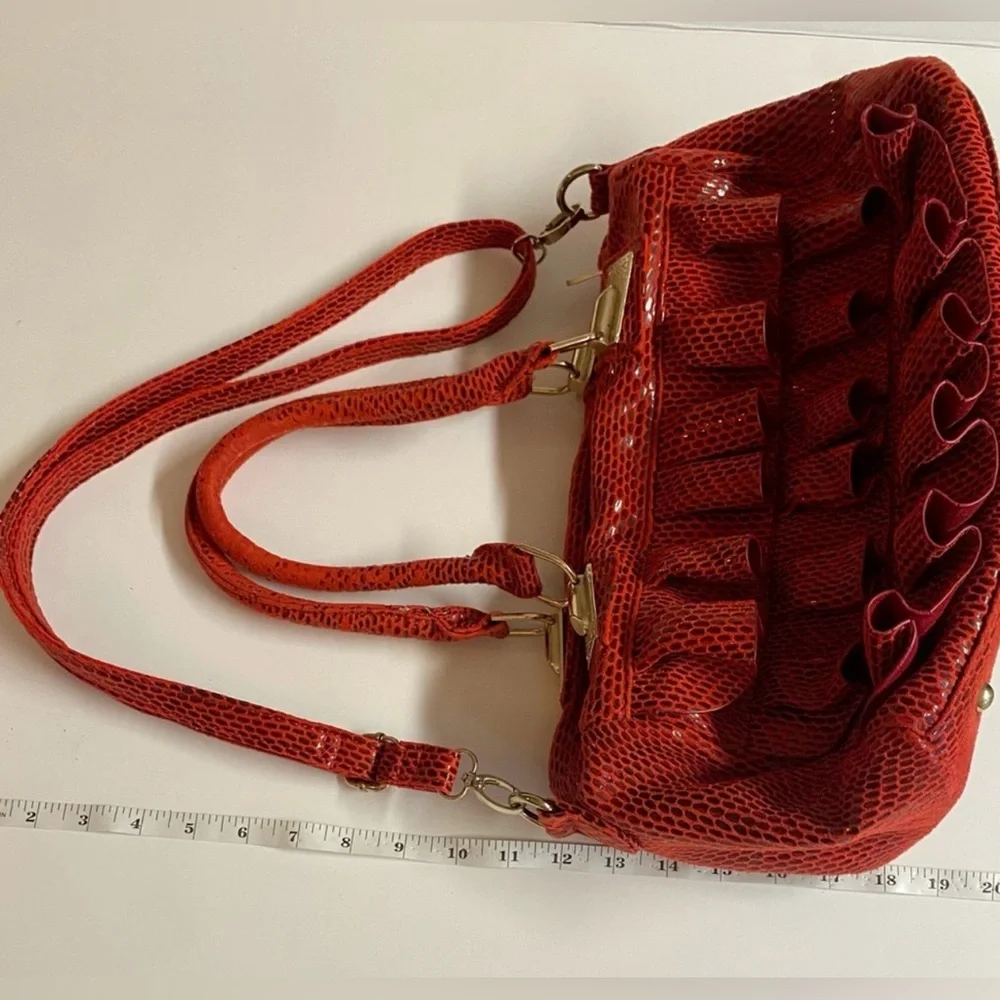Mellow World-Red Ruffle Maximalist shoulder bag with snake print & extra strap.
